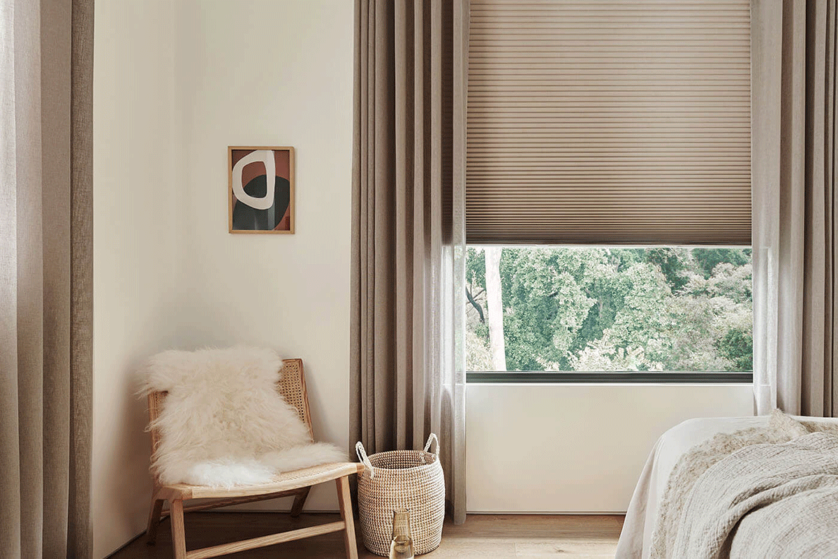 Luxaflex Duette shade framed by curtains and sheers